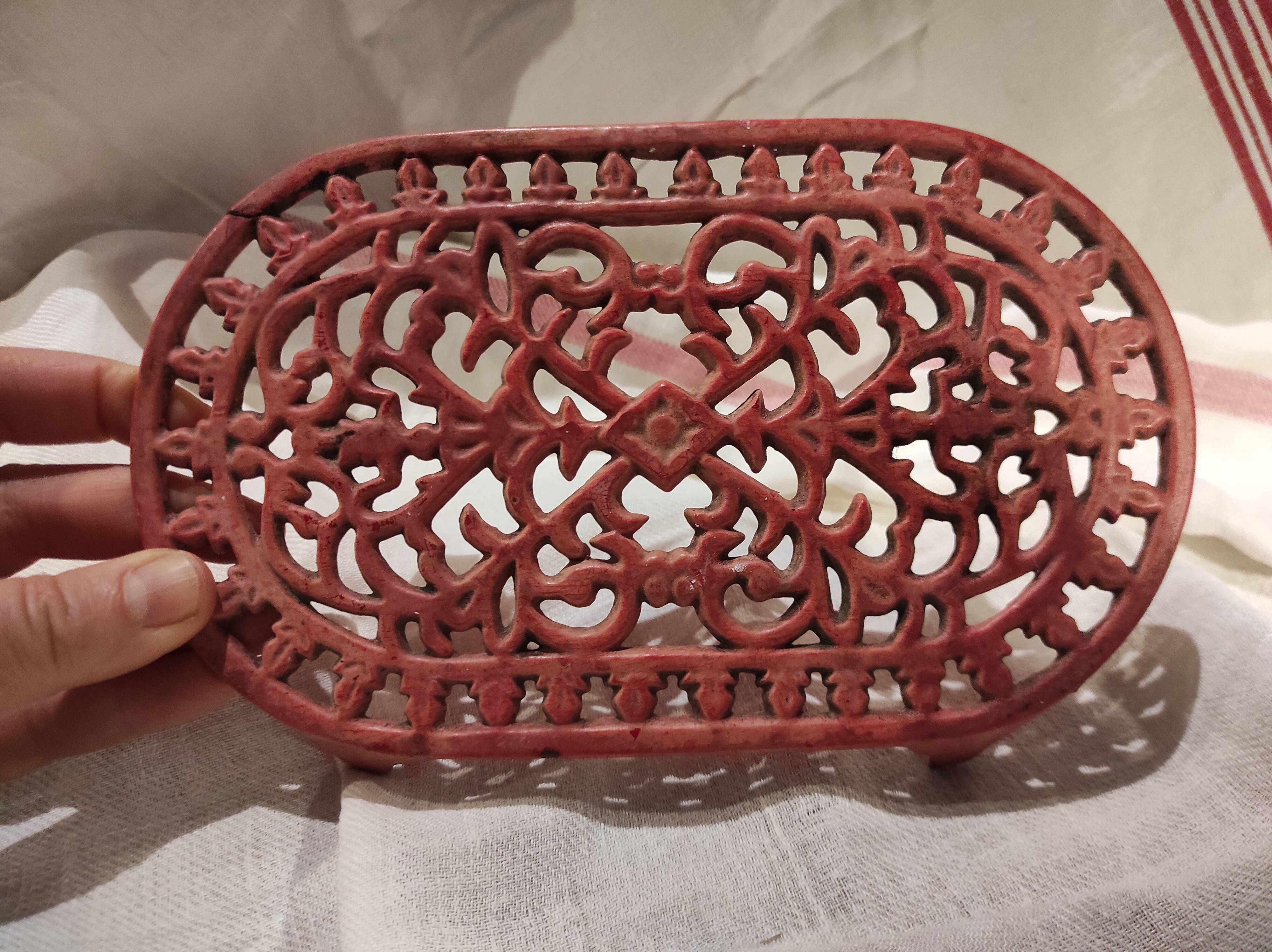 Vintage oval dark coral pink cast iron trivet