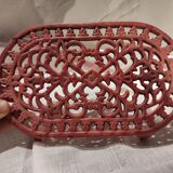 Vintage oval dark coral pink cast iron trivet