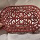 Vintage oval dark coral pink cast iron trivet