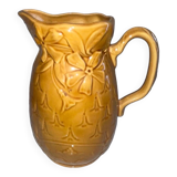 Old pitcher decorated with flowers