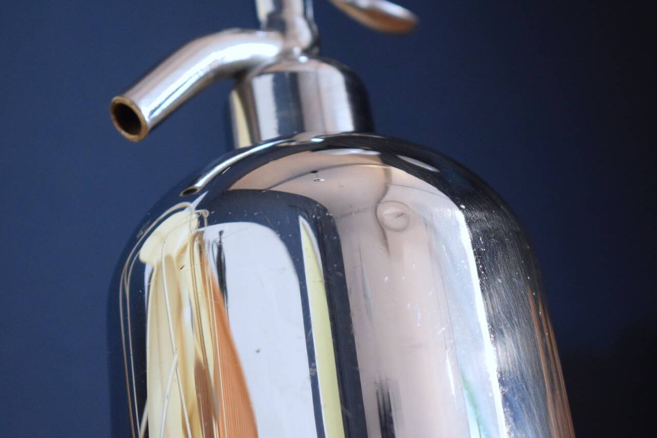 Silver metal siphon.