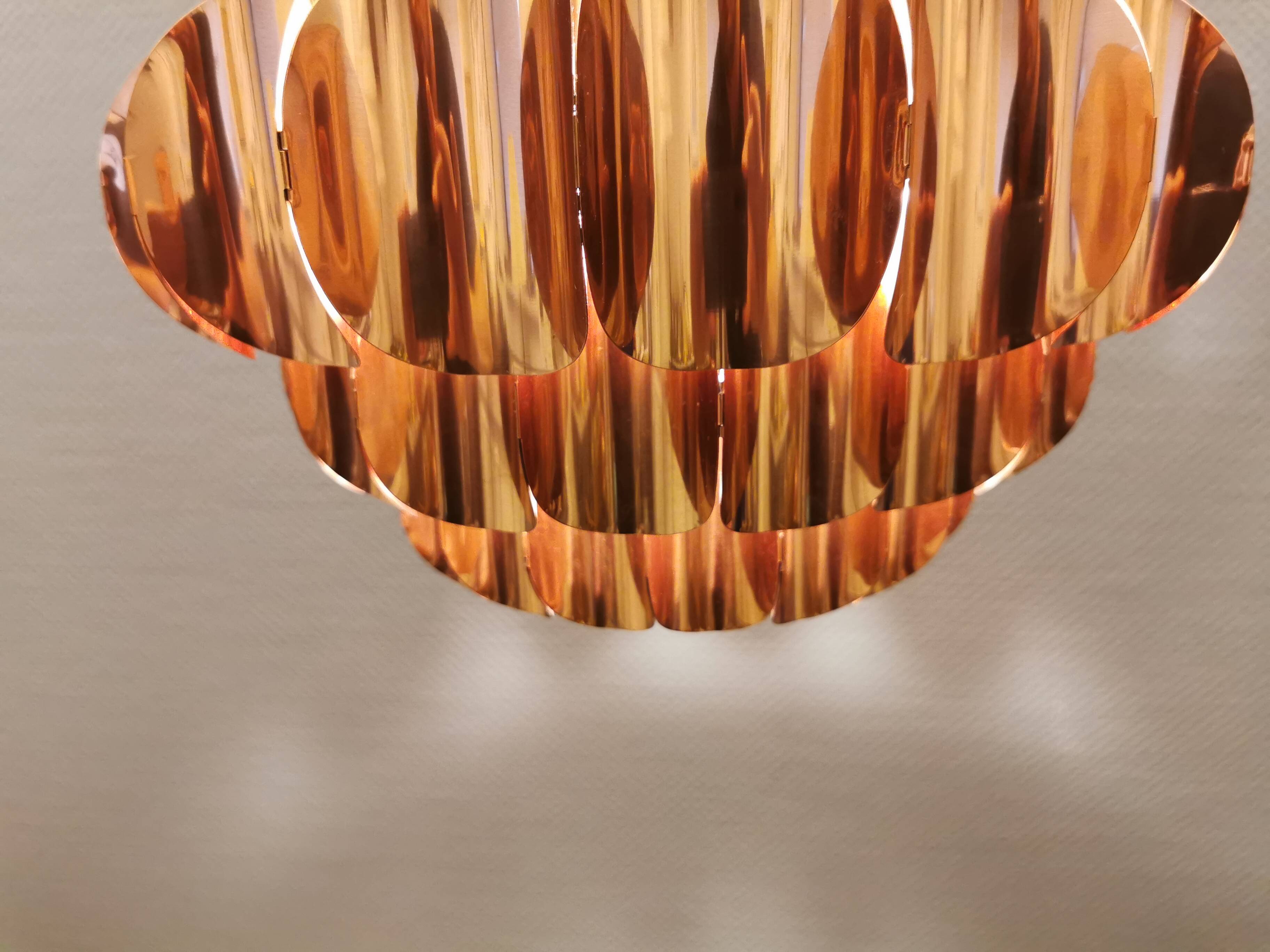 Copper colored hanging lamp. designed by thorsten orrling sweden