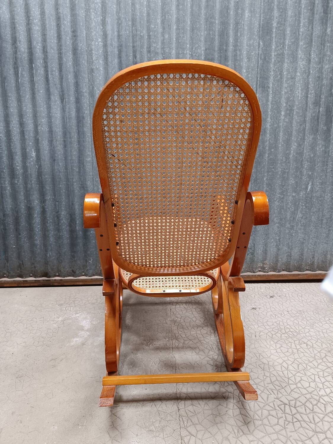 Rocking chair made of bent wood and rattan wicker.