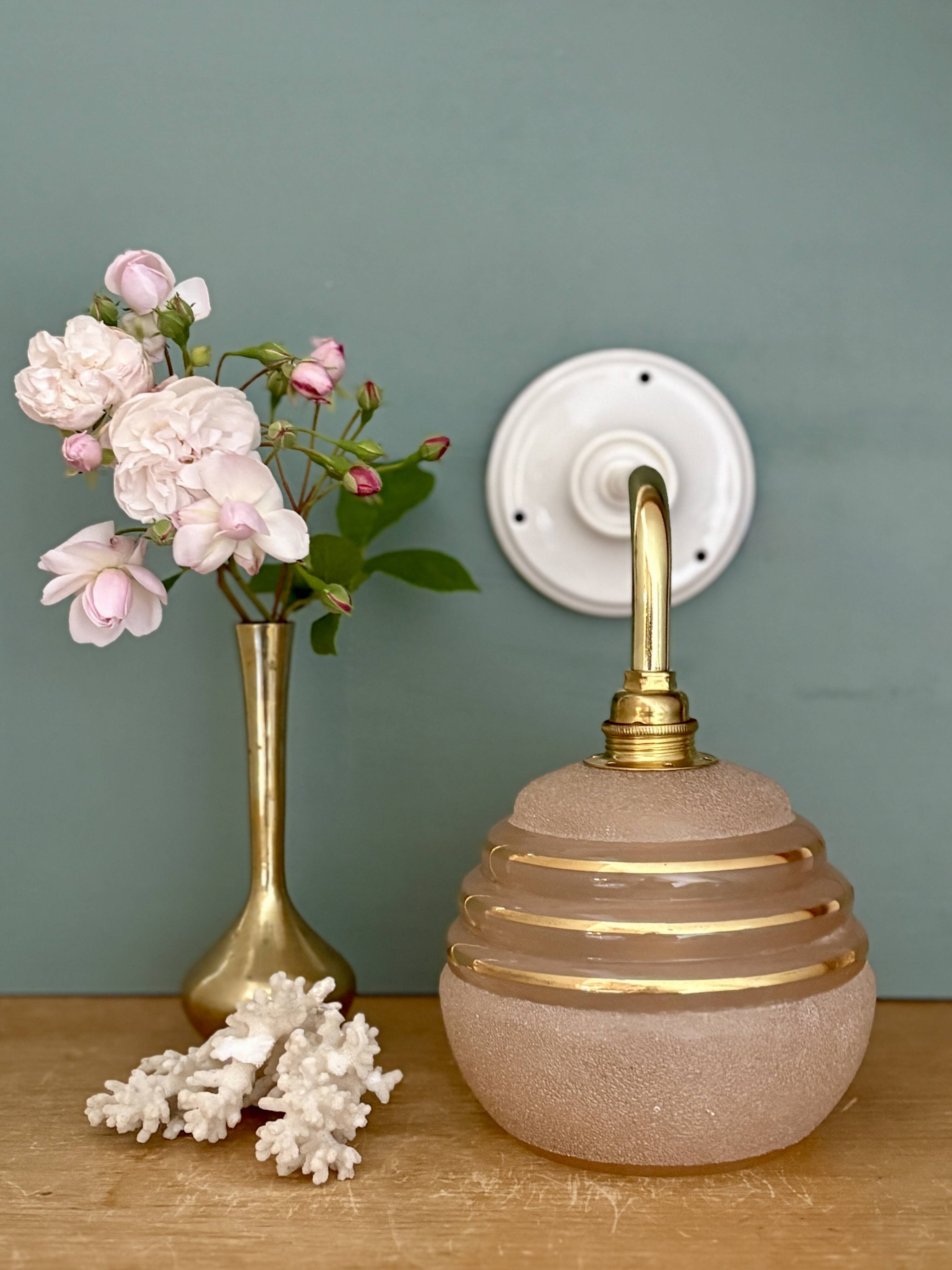 Vintage pink and gold frosted glass globe wall light.