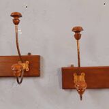 Pair of double coat hooks from the end of the 19th century, circa 1900, in wood and varnished metal