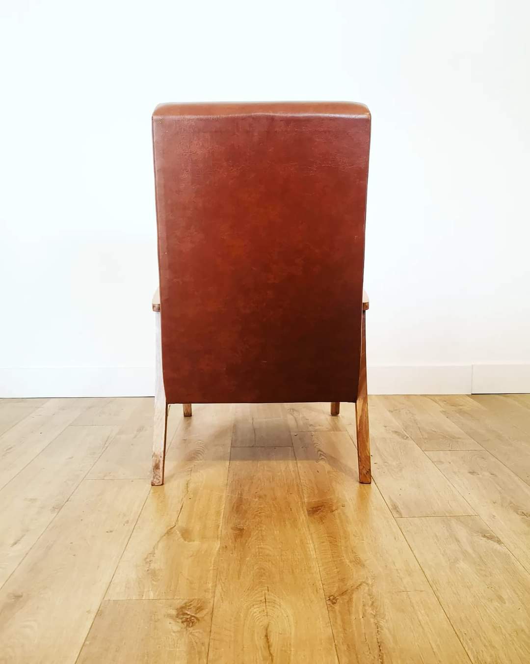 70 armchair in brown skai and wooden structure