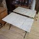 Pair of bistro tables in marble and cast iron.