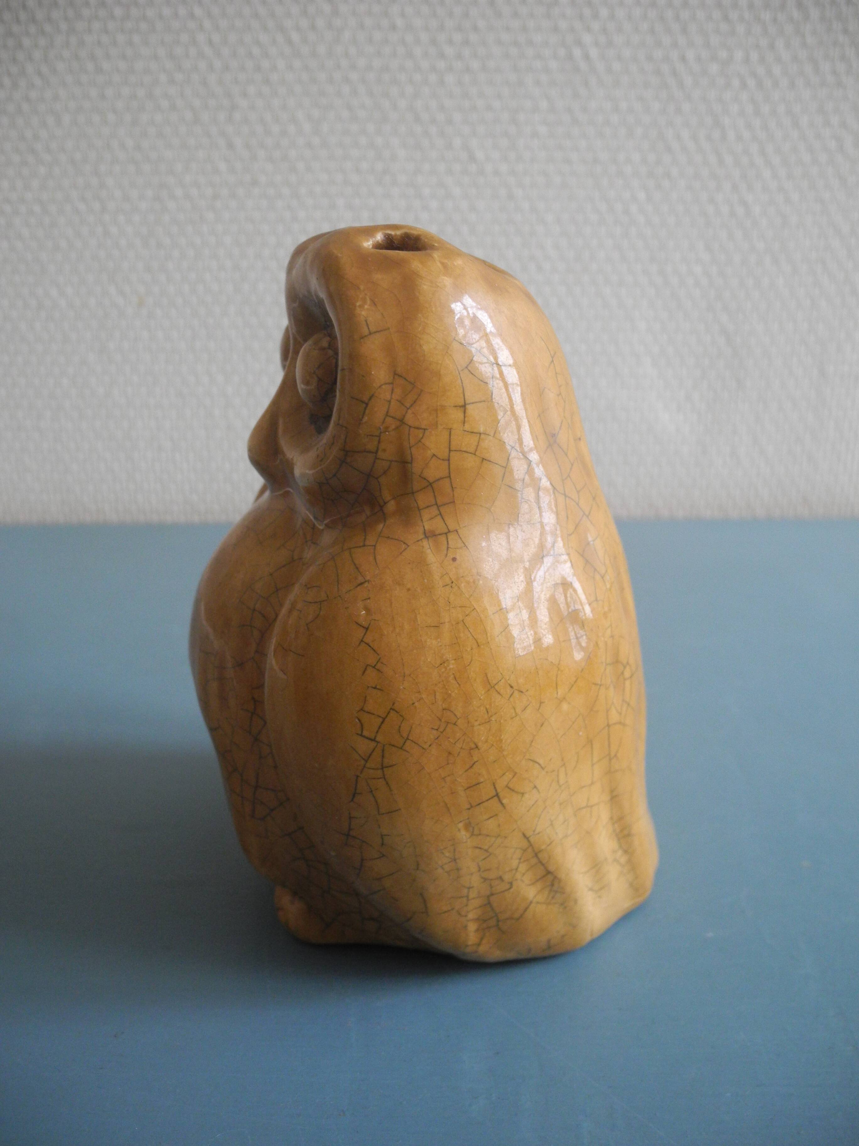 vintage earthenware vase with an old flower pick and an owl decoration
