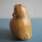 vintage earthenware vase with an old flower pick and an owl decoration