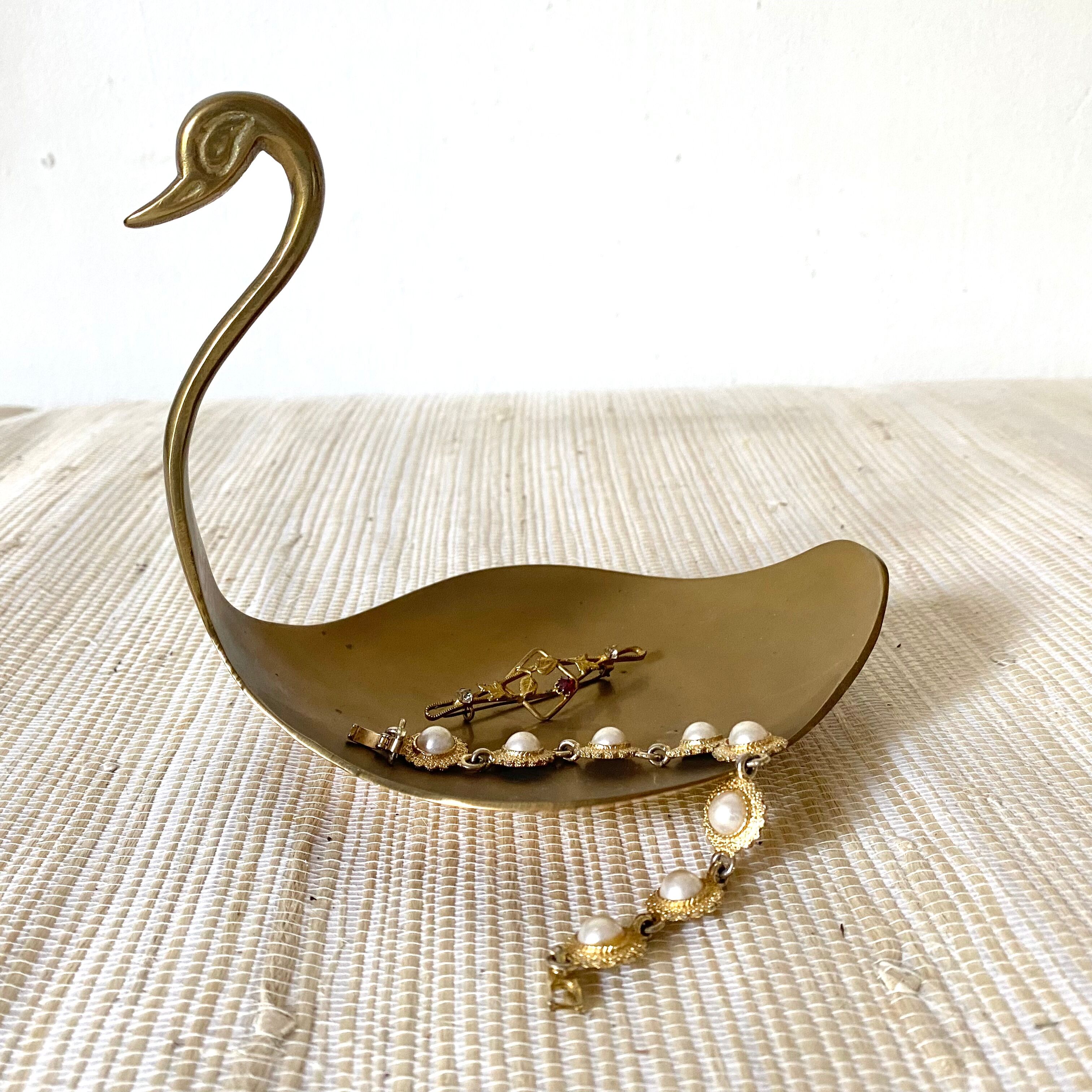 Empty brass swan pocket