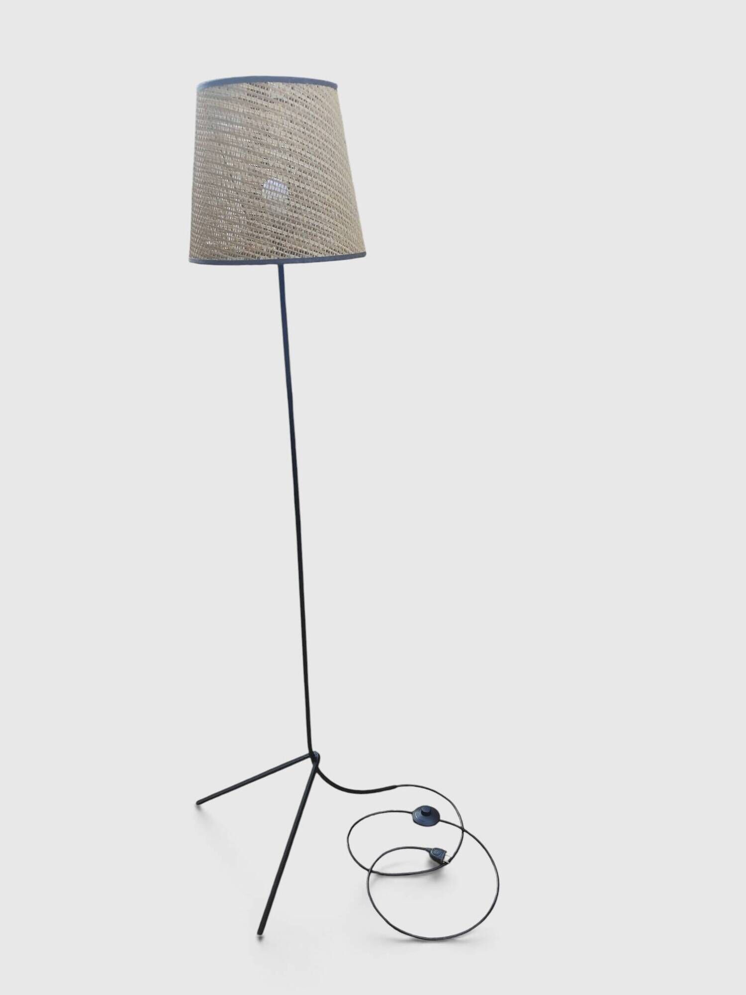Modernist tripod floor lamp in black metal and cane from the 1950s/1960s.