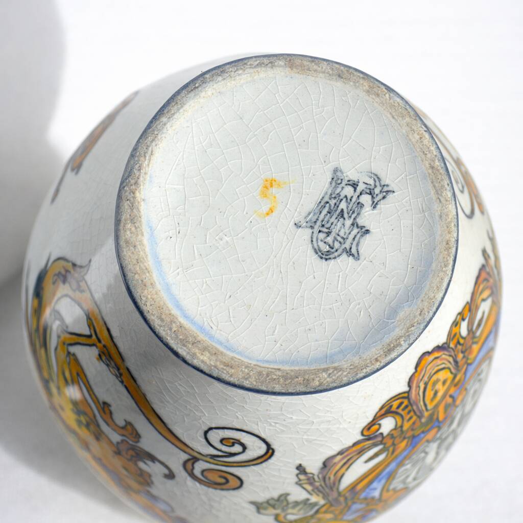 Gien earthenware jug, Renaissance decoration, putto with dolphin.