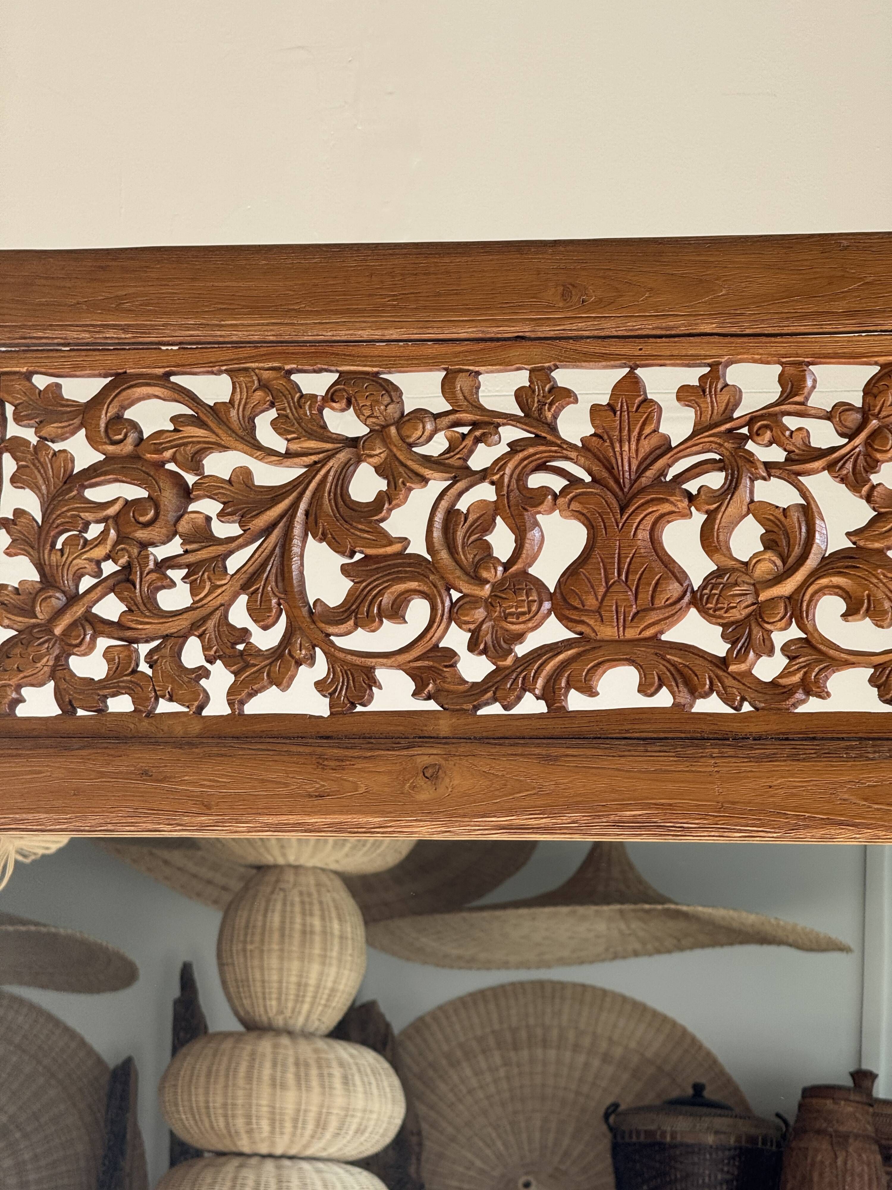 Very large freestanding teak mirror with an openwork carved pediment, Indonesia.