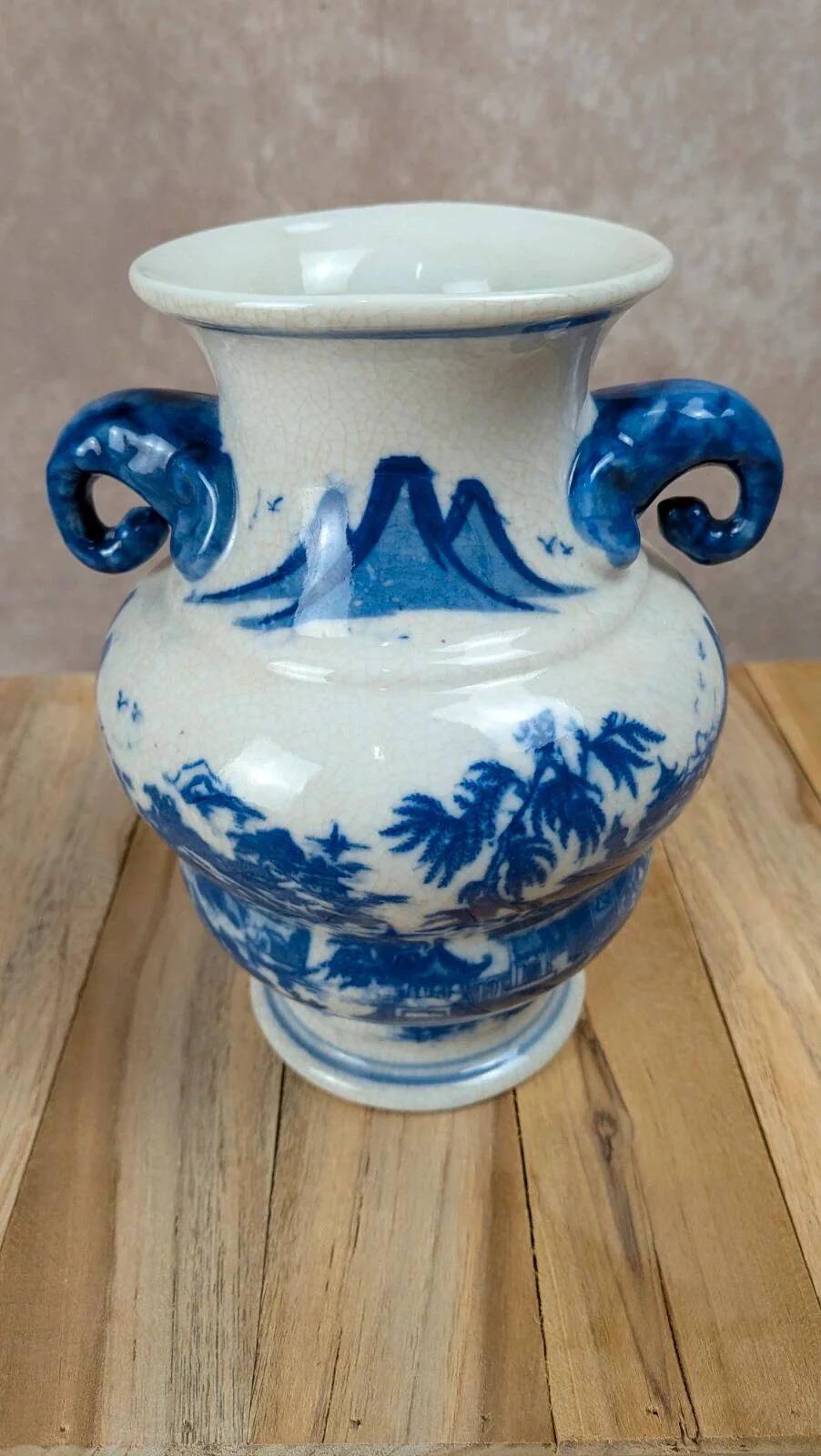 Blue and white Chinese vase with sculpted handles and landscape decoration.