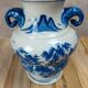 Blue and white Chinese vase with sculpted handles and landscape decoration.