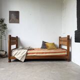 Brutalist style bed with chain and straw