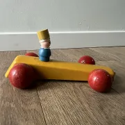 Vintage wooden pull toy, yellow car and small soldier.