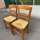 2 wooden dining chairs with rush seats from the 1970s.