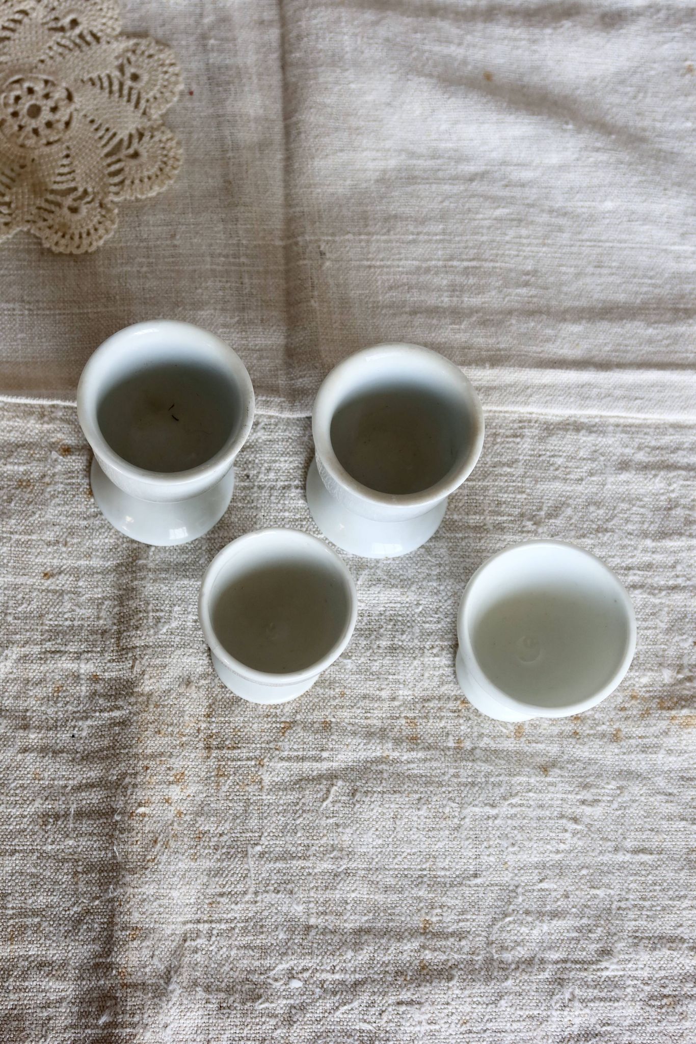 4 mismatched vintage white porcelain egg cups