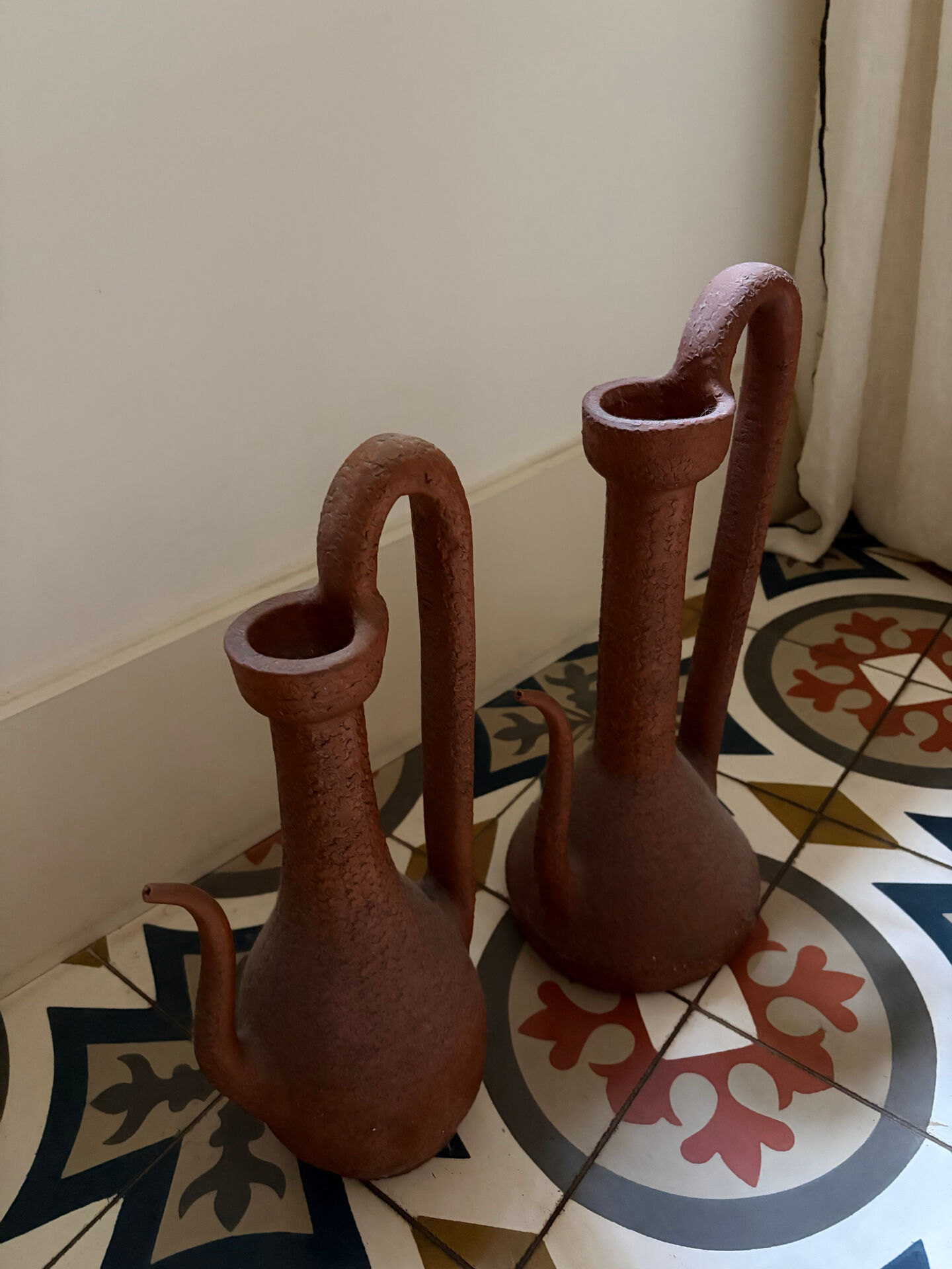 Pair of decorative terracotta jars, in the shape of a ewer.