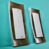 Pair of wall sconces in gold-plated alloy with bas-relief and opaline glass. Germany, 1980