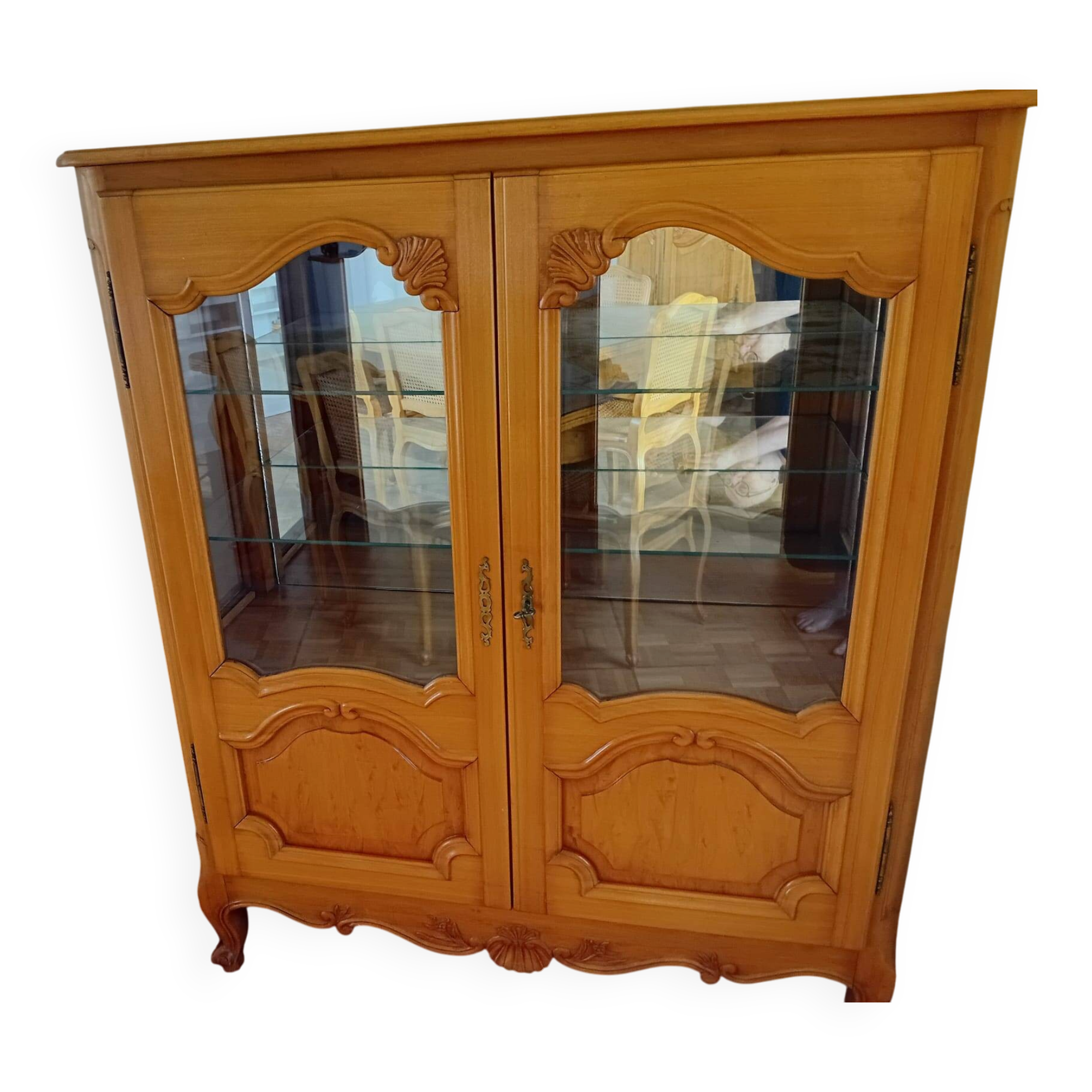 Showcase with shell mouldings in wood, glass, and mirror.
