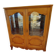 Showcase with shell mouldings in wood, glass, and mirror.