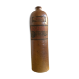 Old stoneware bottle with small handle and labels