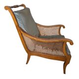 Regency style bergère armchair in wood, fabric and cane