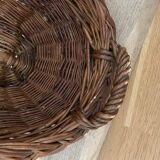 Vintage brown wicker baguette basket, elongated shape, with integrated handles.