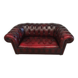 Upholstered burgundy leather Chesterfield sofa