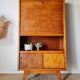 Vintage 1950s wooden secretary with tapered legs and mint interior.