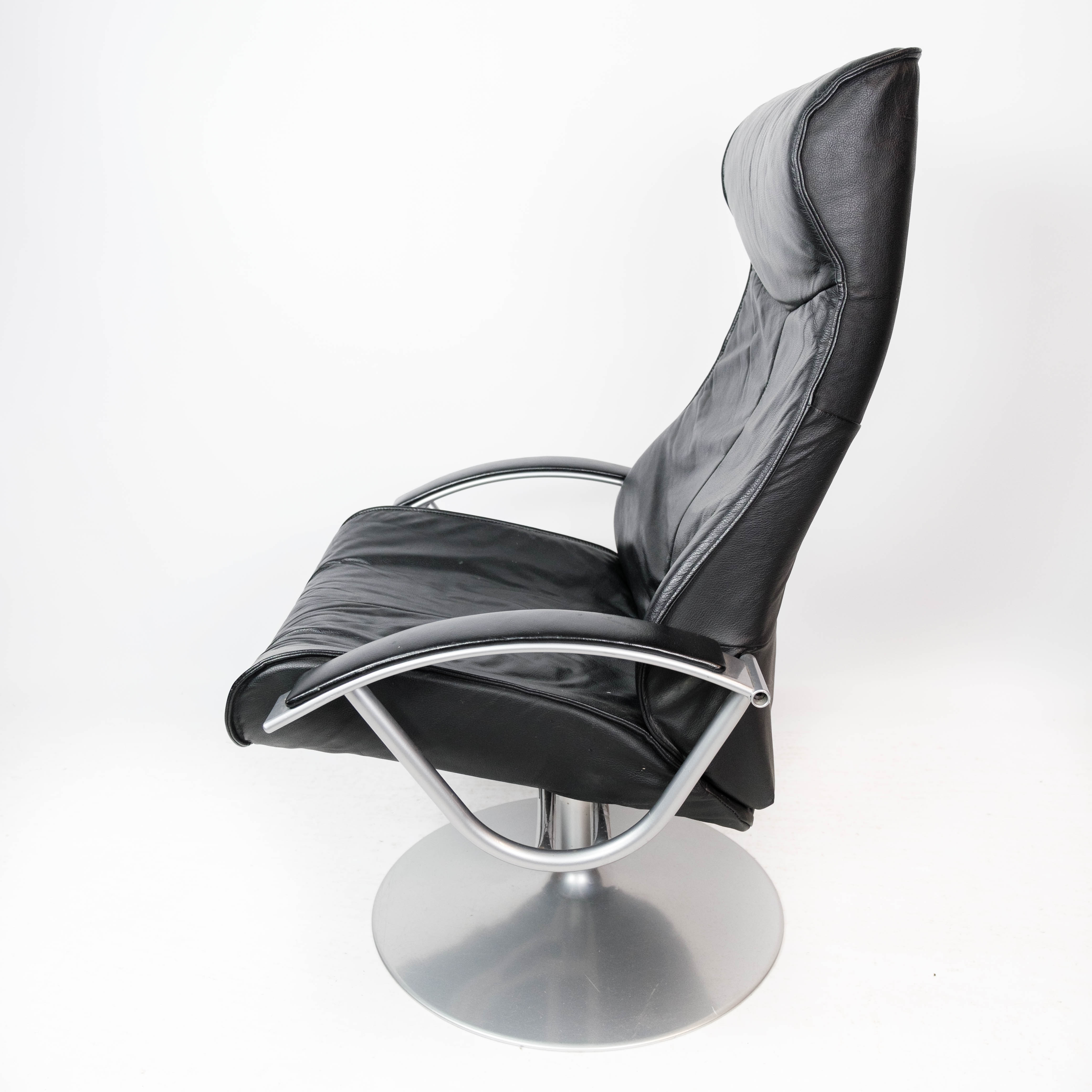 Easy chair with stool upholstered with black leather of Danish design, 1970s