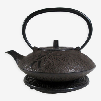 Antique cast iron teapot decorated