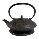 Antique cast iron teapot decorated