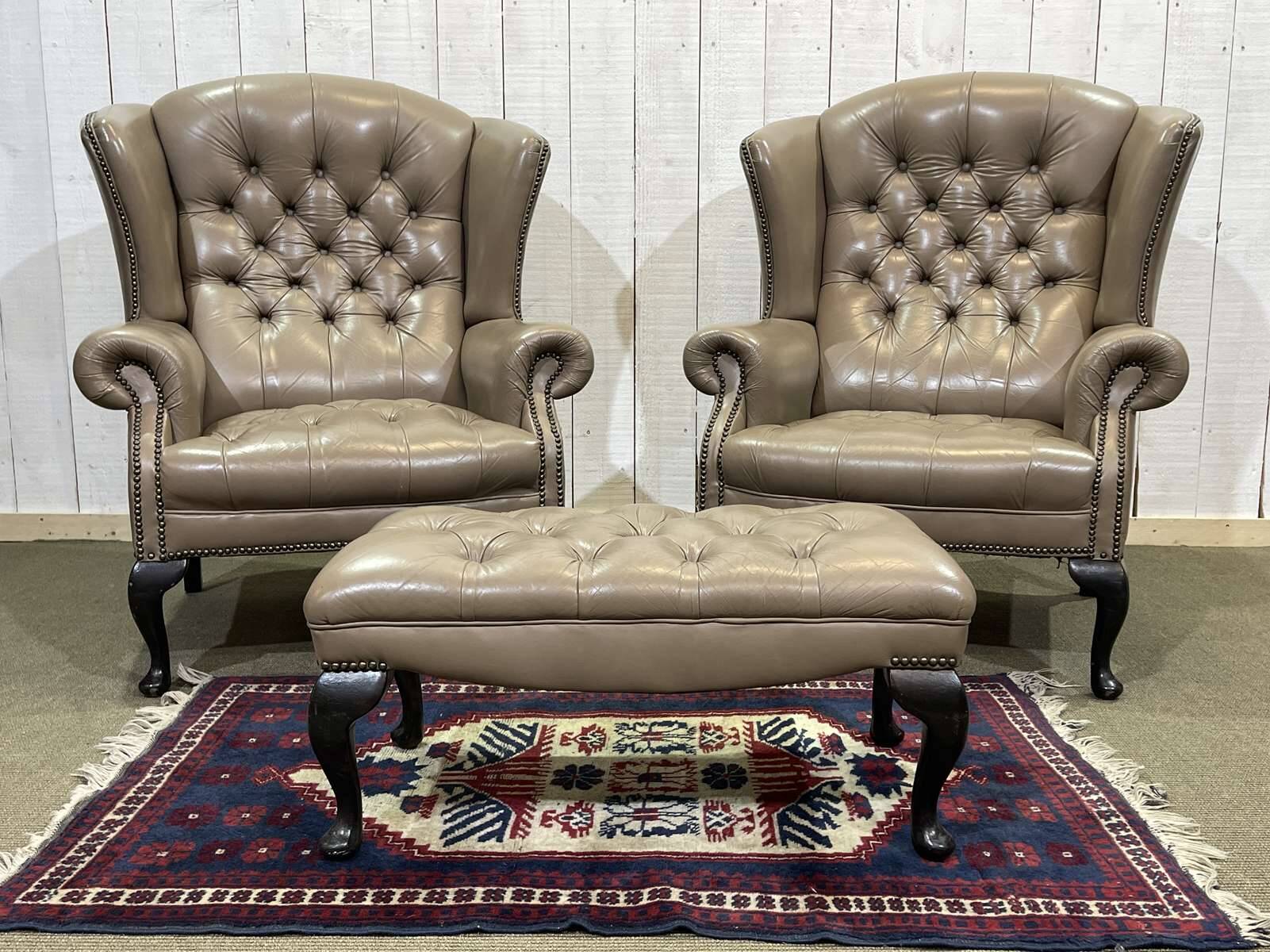 Pair of high-backed Chesterfield armchairs with 1 leather footrest