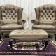 Pair of high-backed Chesterfield armchairs with 1 leather footrest