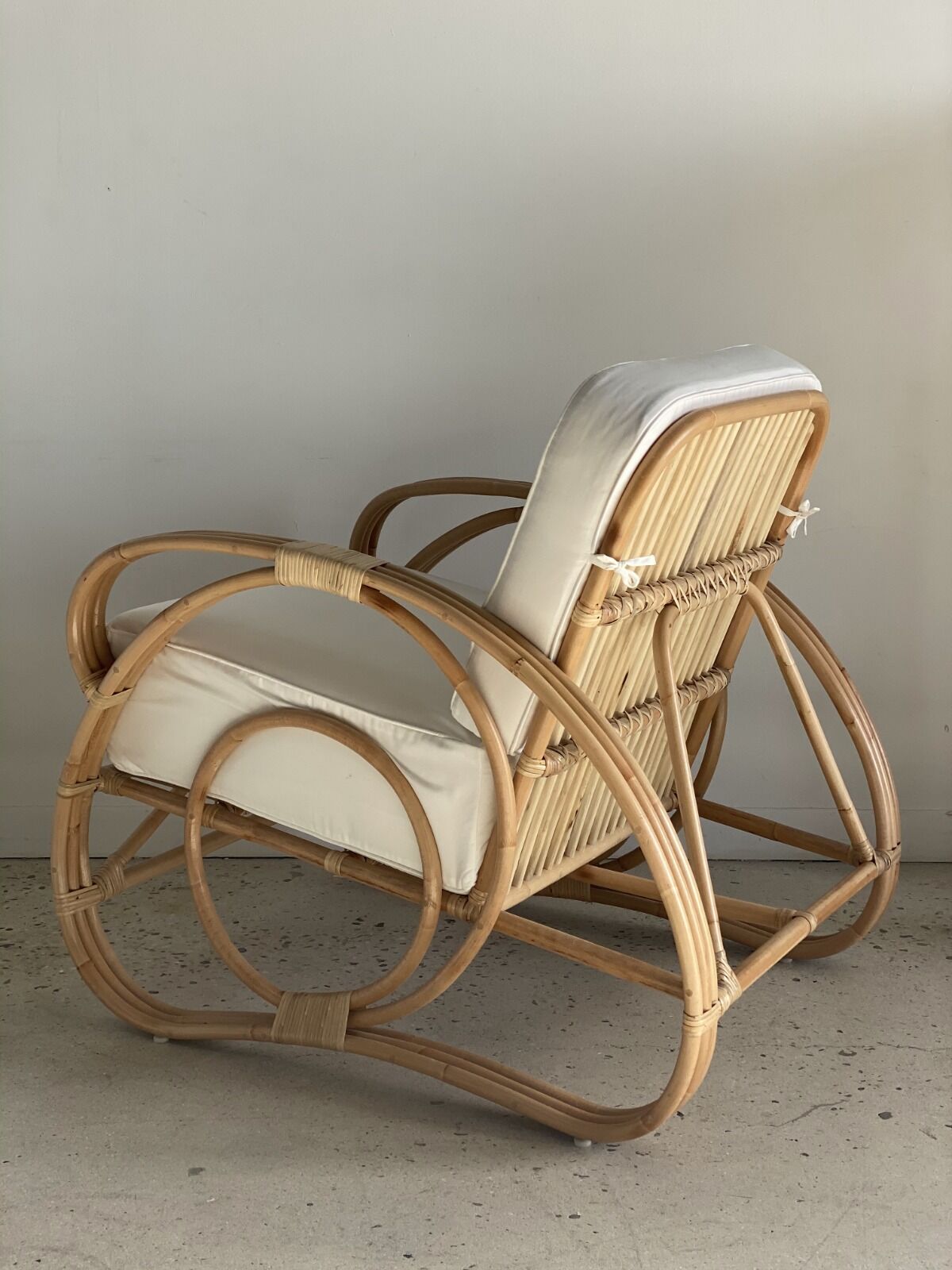 Large rattan rest chair and white cushions