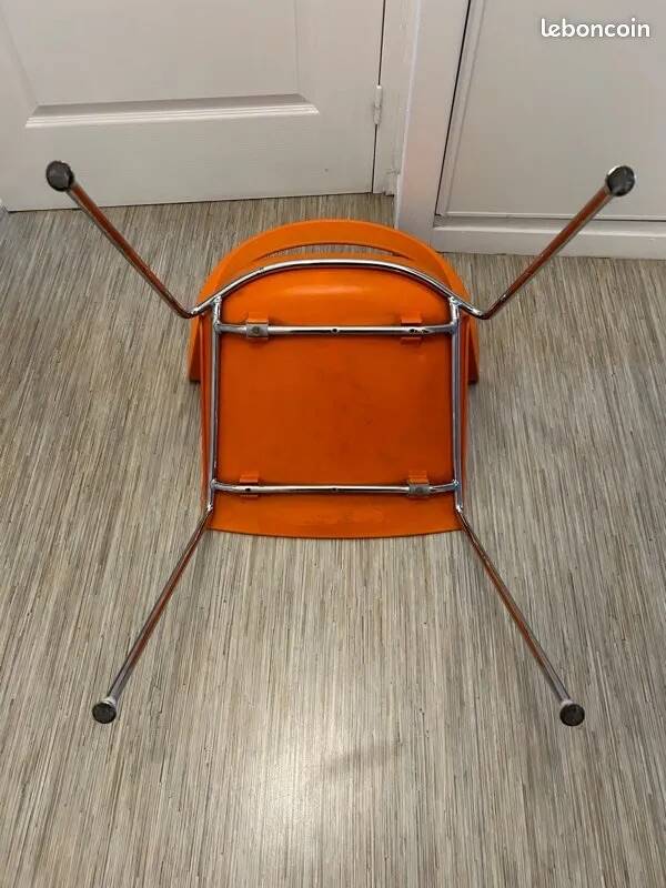 Two orange kicca chairs made in italy tbe
