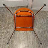 Two orange kicca chairs made in italy tbe