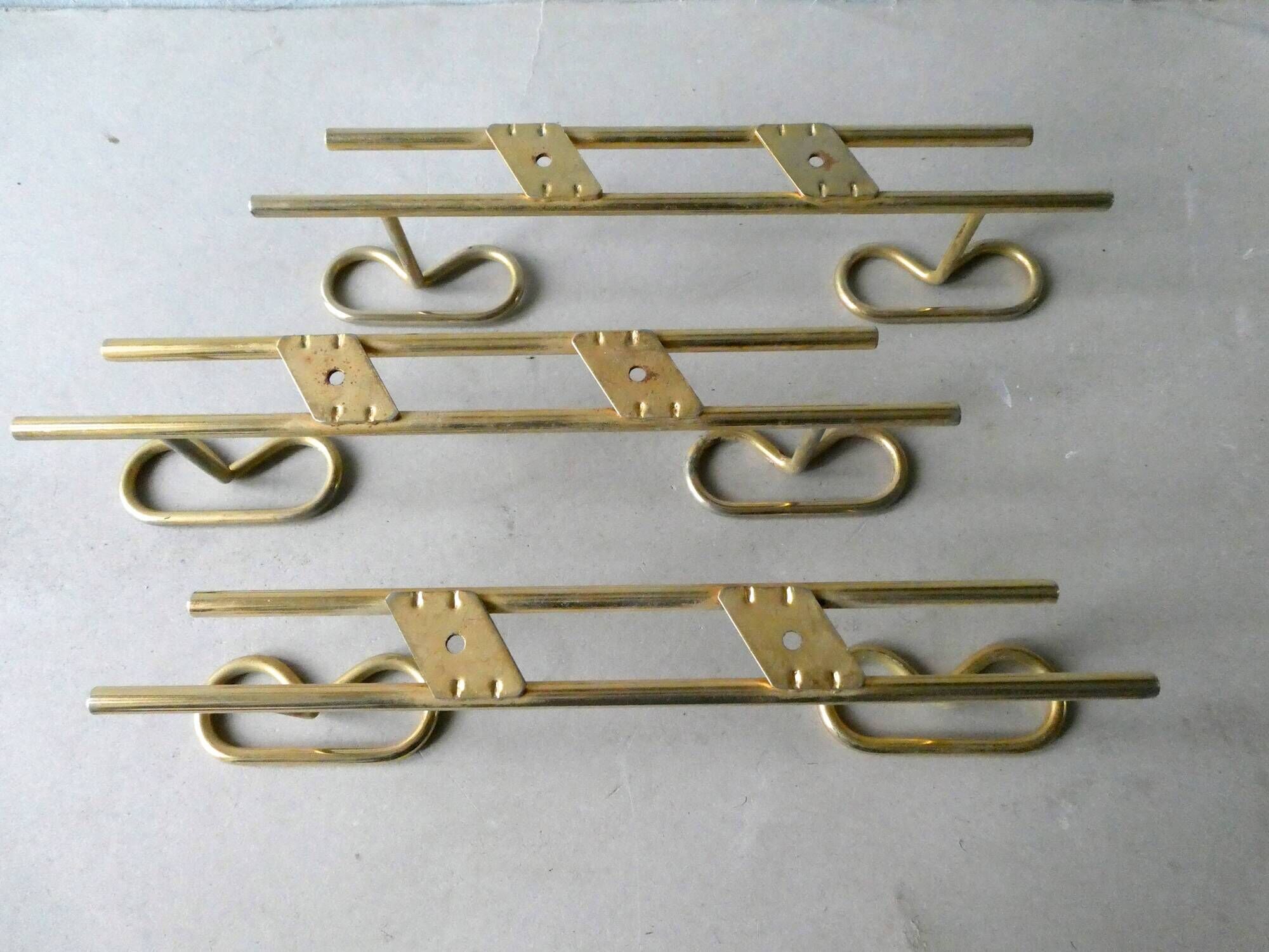 Set of 3 coat hangers in gold metal, 60s