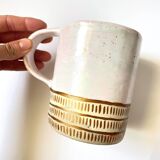 Handmade golden ceramic mug