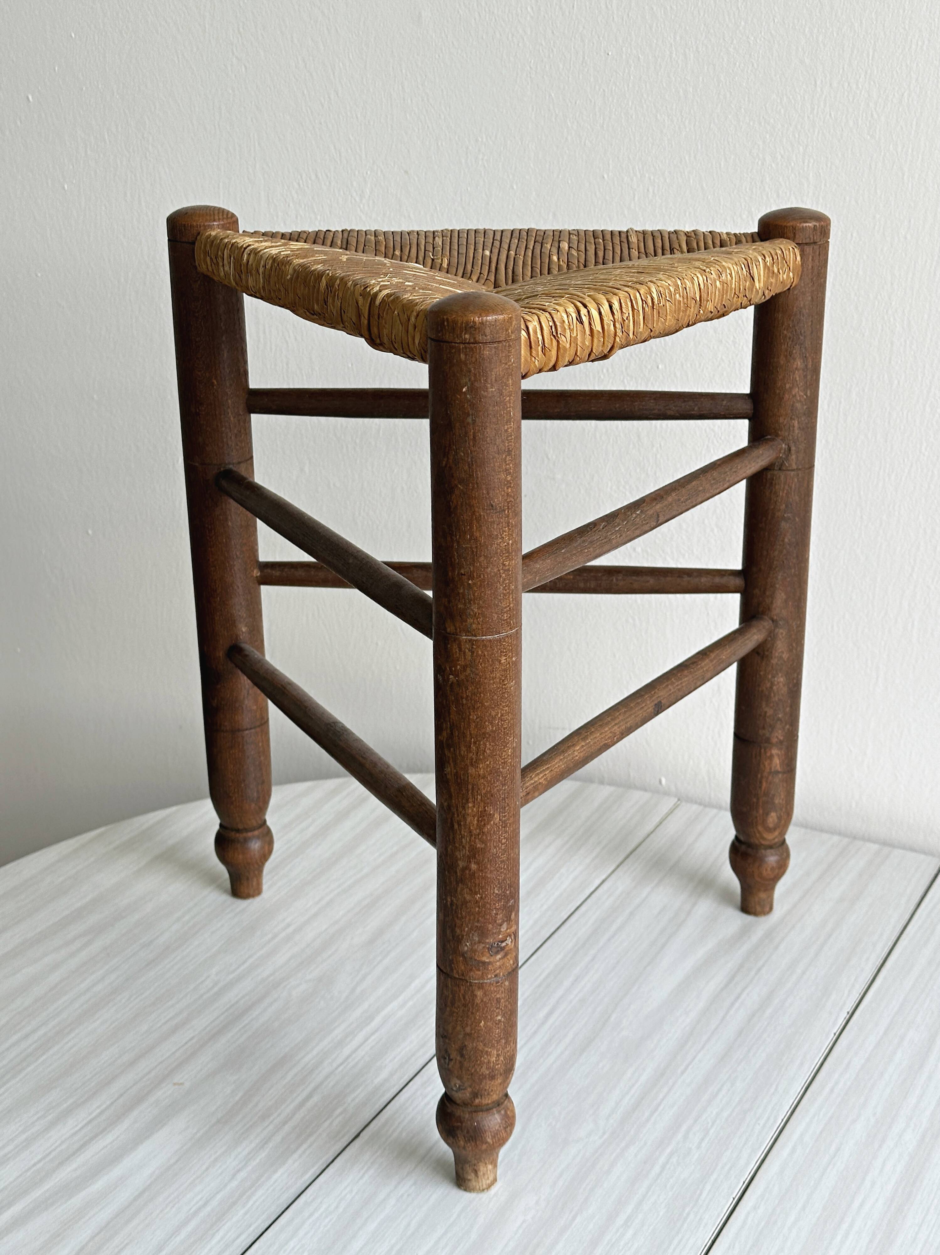 Triangular turned wooden stool