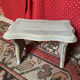 Small footrest bench in solid wood with a slate grey patina.