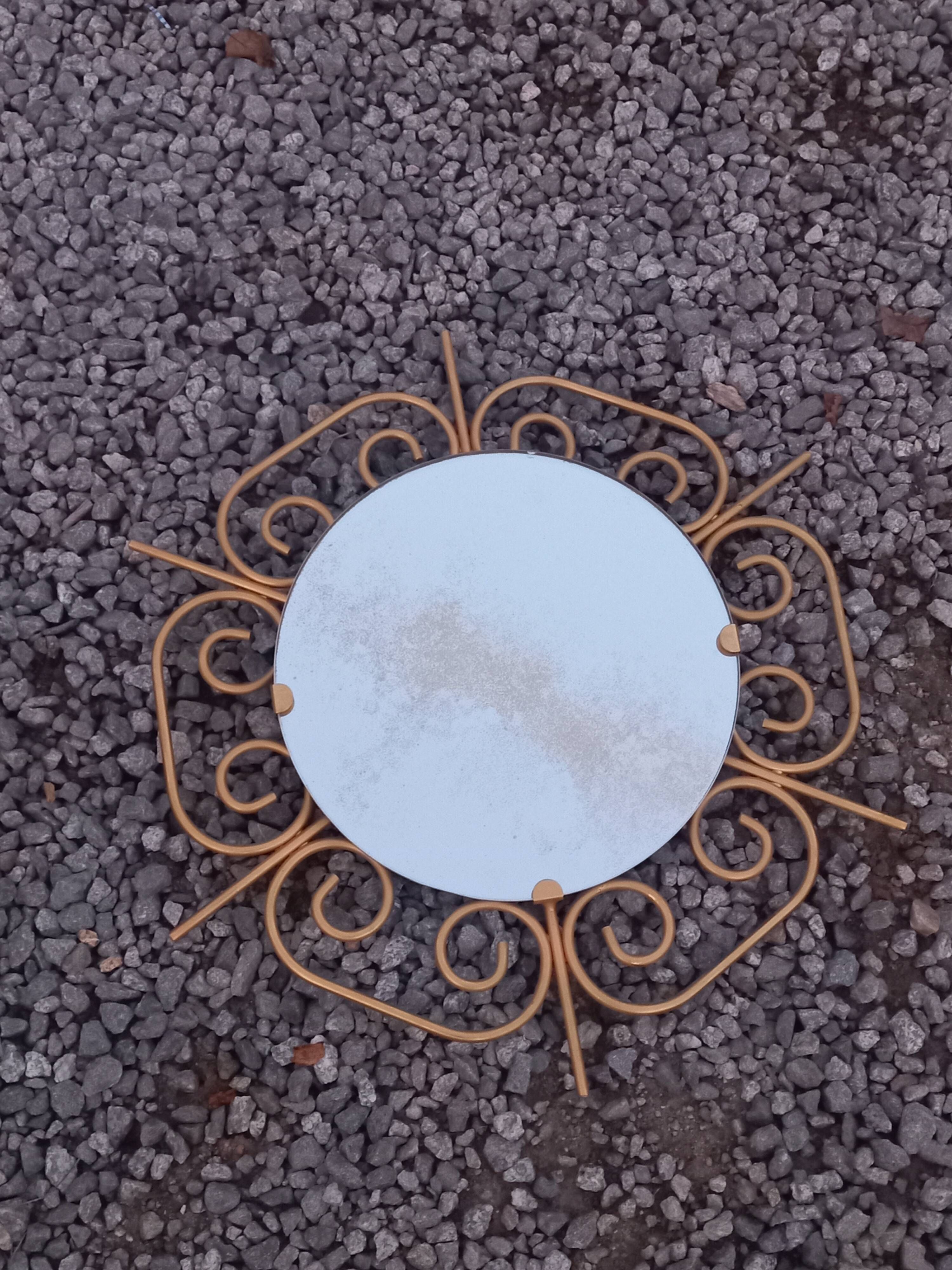 Golden metal sun mirror from the 1950s.
