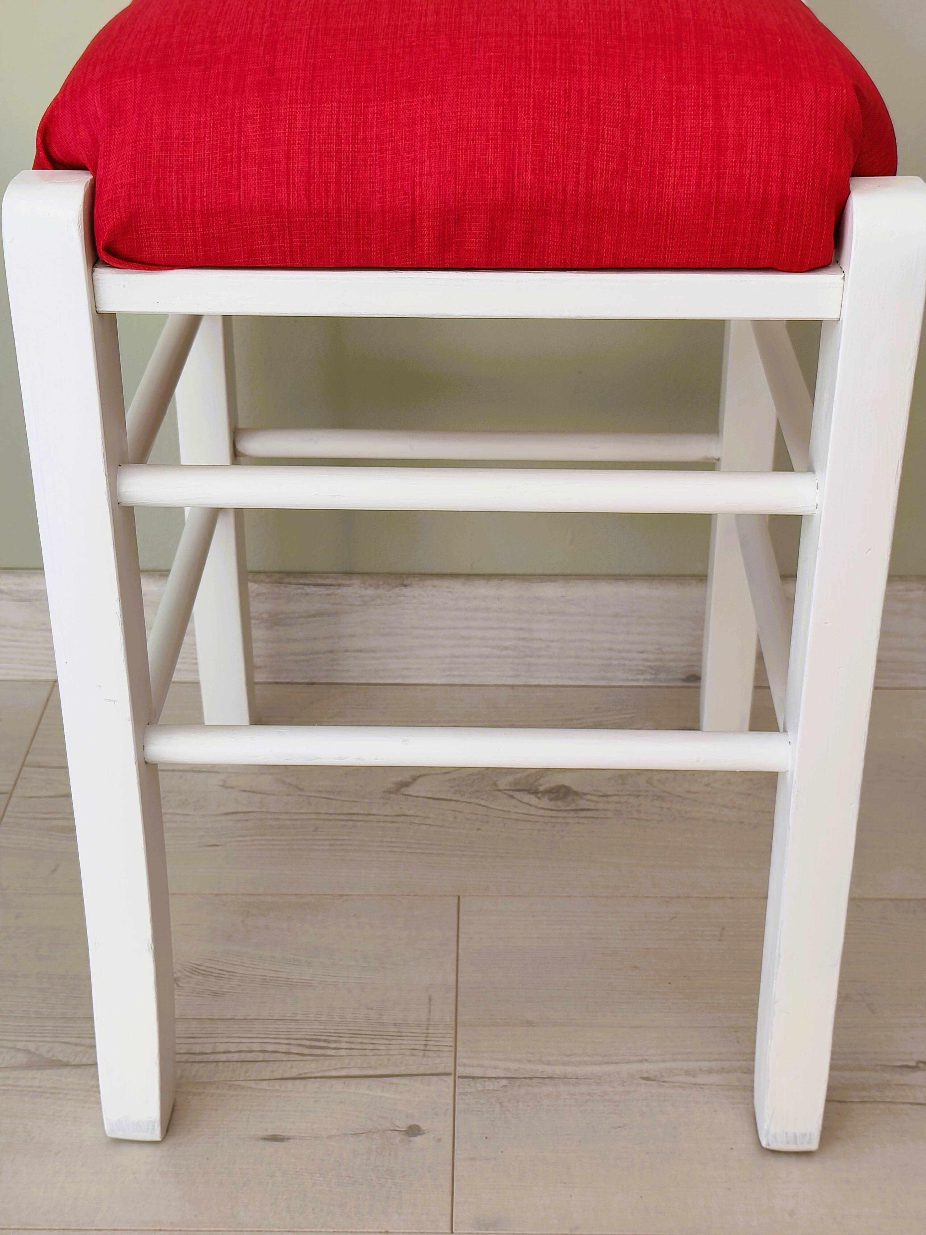 White pine stool with a red seat.