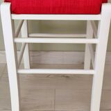 White pine stool with a red seat.