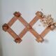 Wall-mounted accordion coat rack in solid pine