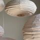 Average suspension in natural rattan and linen, Japanese-style, flattened oval in pink.