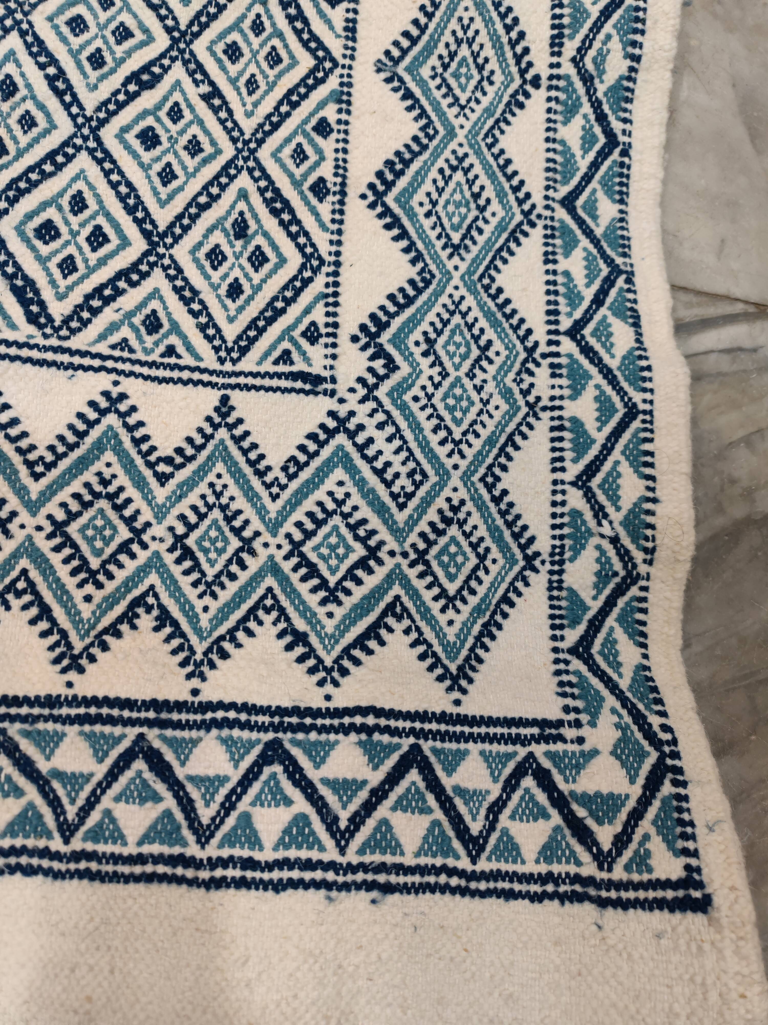 White and blue hand-woven rug in natural wool